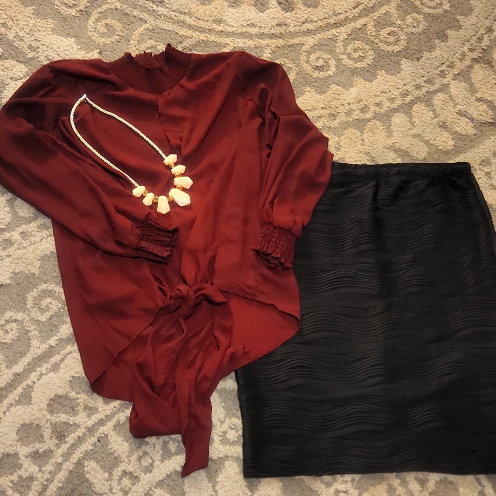 Blouse and skirt with necklace.